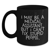 Load image into Gallery viewer, Medical Assistant Humor Black Coffee Mug, Funny Birthday Unique Gifts from Friends to Medical Assistant, I May Be A Medical Assistant, But I Can&#39;t Fix Stupid People. - Main
